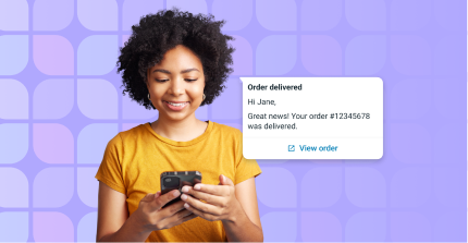 A woman using a phone to send whatsapp campaigns